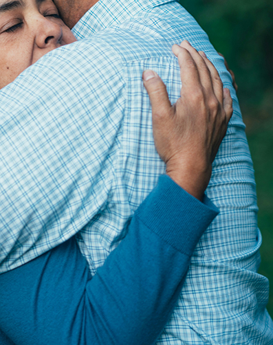 One person hugging another to provide support One person hugging another to provide support