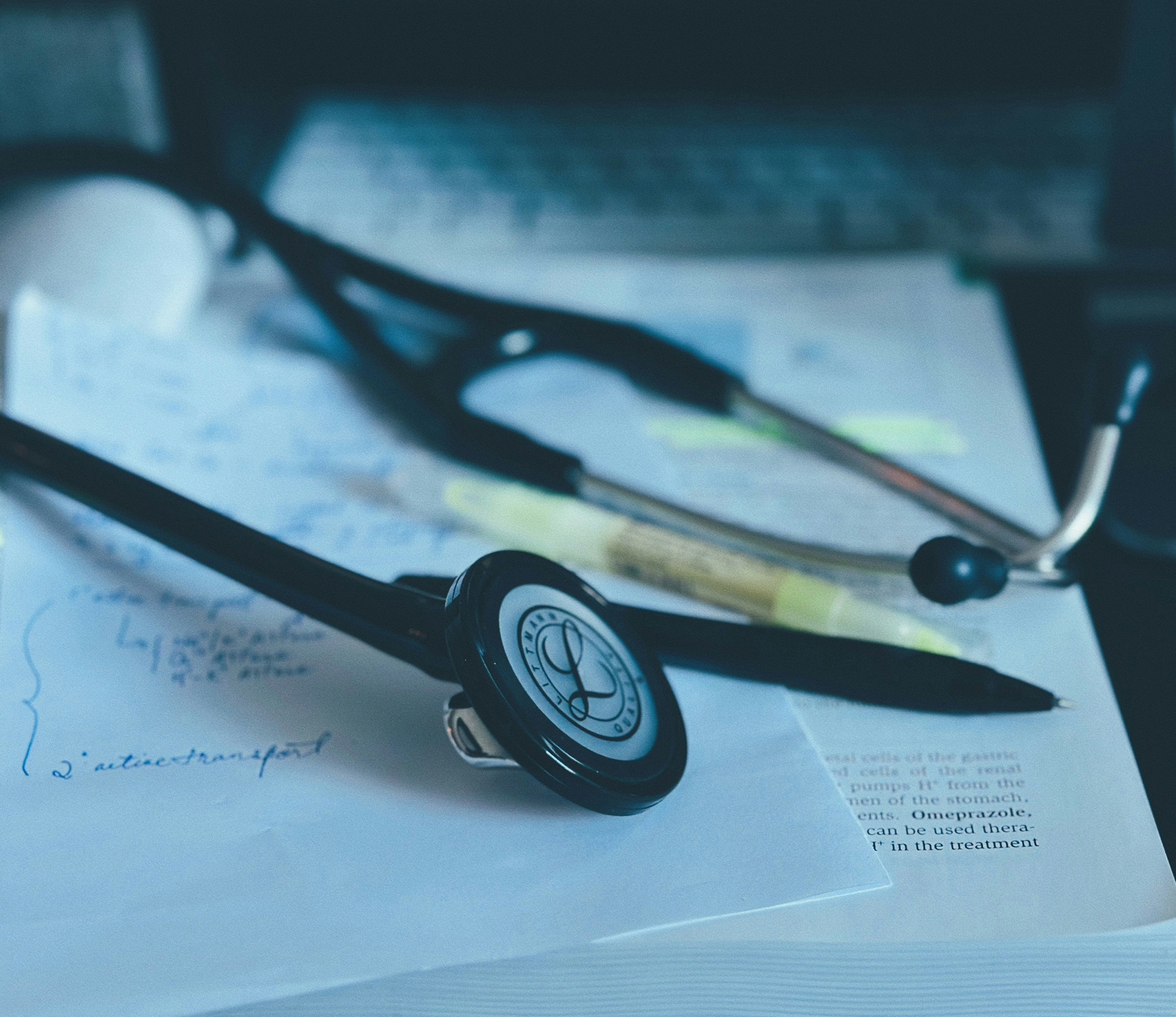 Documents, a stethoscope, and a pen on the table Documents, a stethoscope, and a pen on the table
